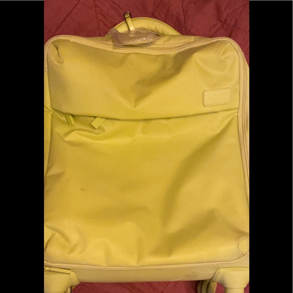 Lipault neon colored spinner carry on luggage